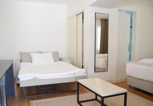 a bedroom with a bed and a table and a mirror at niXie Hotel Bodrum in Bodrum City