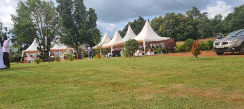 a group of white tents in a field at Hotel Judith, GULU in Buwate