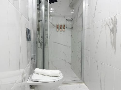 a white bathroom with a shower and a toilet at niXie Hotel Bodrum in Bodrum City