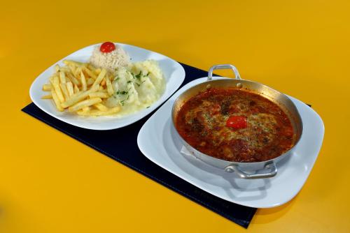a plate of food with a bowl of chili and french fries at Golden Tower Express Anhembi by Fênix Hotéis in Sao Paulo