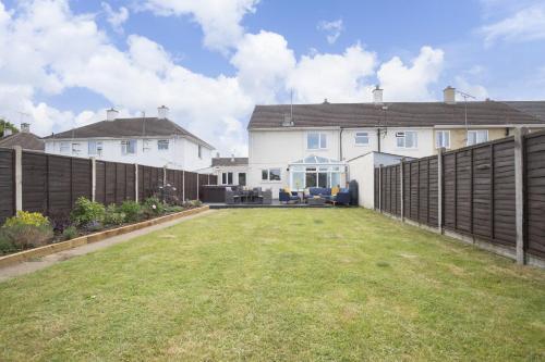 a large yard in front of a house with a fence at 4 Bedroom Home with Hot Tub near Gloucester City in Gloucester