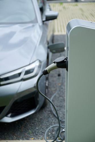 a white car is plugged into a charger at Melea - The Health Concept - Adults Only Hotel in Sárvár