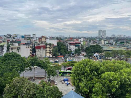 a view of a city with buildings and trees at Hanique Cafe and Stay in Hanoi