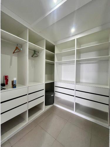a large white walk in closet with white shelves at Casa BB&Djassi - Apartment T2 in Ponta do Sol