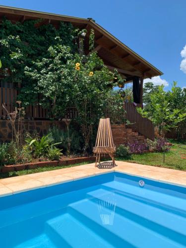 a swimming pool in a yard with a pergola at La casa del Lago - The lake house ! in Puerto Iguazú
