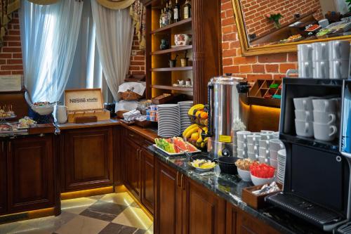 a kitchen with a counter with food on it at Hotel Polonia in Kraków