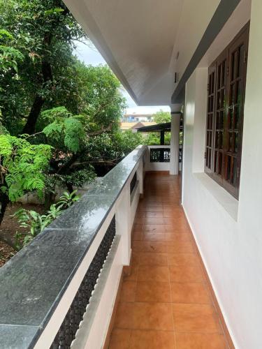 a corridor of a house with a walkway at SatyaYam Park Villa in Cochin