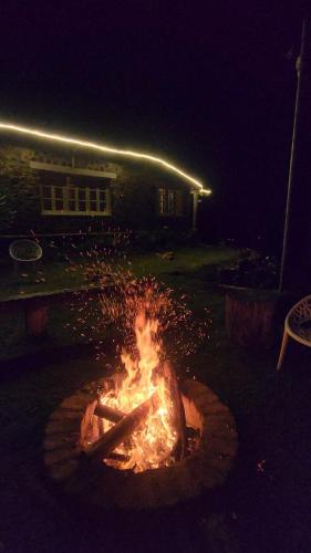 a fire pit in front of a house at night at Springdale Villa in Kodaikānāl