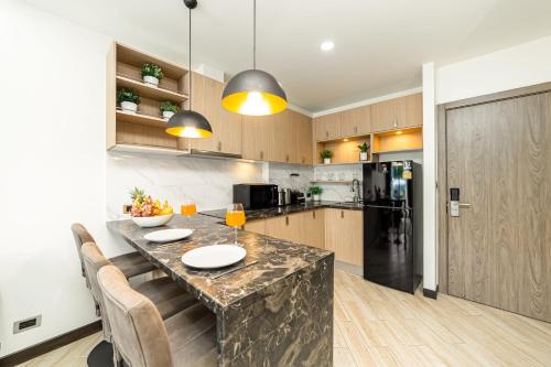 a kitchen with a large marble counter top in a room at Calypso Garden Residences by Beringela in Phuket Town