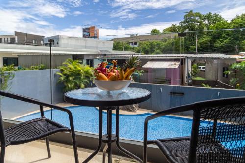 a bowl of fruit on a table on a balcony at Calypso Garden Residences by Beringela in Phuket Town