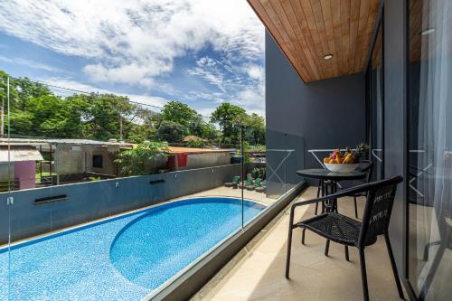 a view from the balcony of a house with a swimming pool at Calypso Garden Residences by Beringela in Phuket Town
