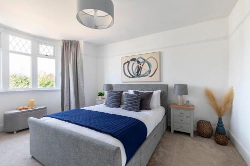 a bedroom with a large bed with a blue blanket at Lythwood House in Gloucester