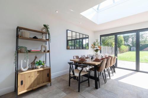 a dining room with a table and chairs at Lythwood House in Gloucester