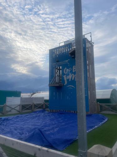 a blue building with a blue tarp around it at Luxury Family Caravan With Decking and Sea View - Sleeps 6 in Allhallows