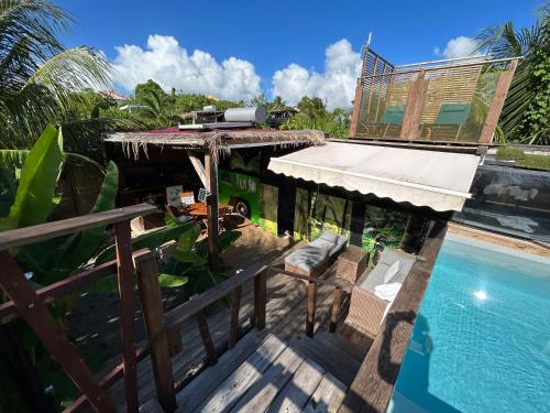 a house with a swimming pool next to a building at Caraibes insolite in Sainte-Luce