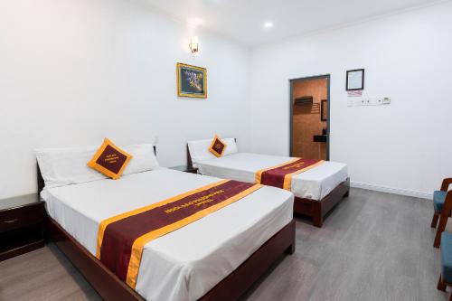 a hotel room with two beds in it at Belvilla Near Quang Trung Exhibition Center District 12 Formerly Southern Star Hotel in Ho Chi Minh City