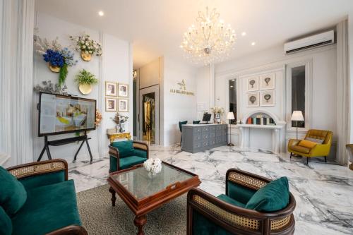 a living room filled with furniture and a chandelier at Ali Grand Hotel in Vientiane