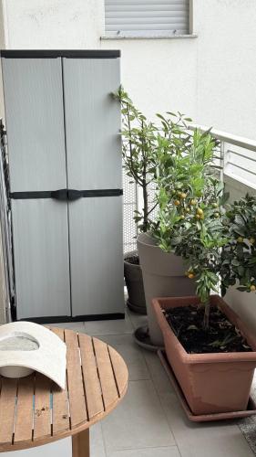 a room with a cabinet and potted plants and a table at Bloom Apartment in Pero