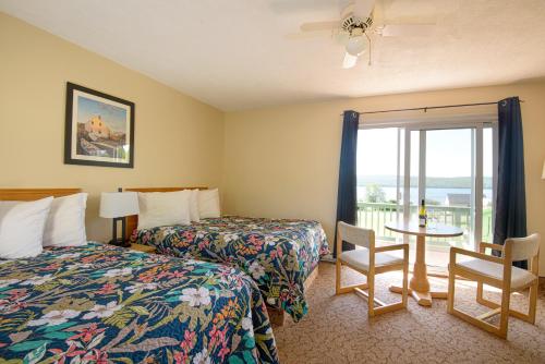Ένα ή περισσότερα κρεβάτια σε δωμάτιο στο Cabot Trail Motel