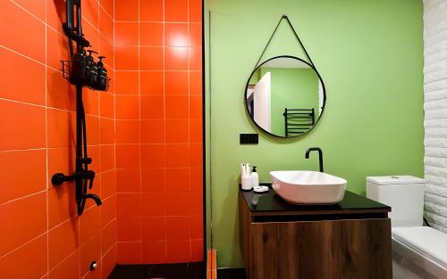 a bathroom with a sink and a mirror at Rooms Apart Hotel by RED in Yerevan