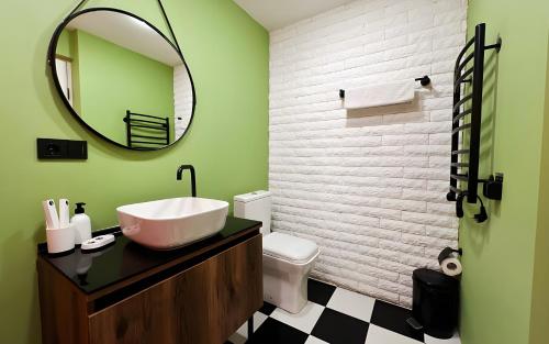 a bathroom with a sink and a mirror at Rooms Apart Hotel by RED in Yerevan
