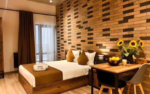 a hotel room with a bed and a table with a table at Rooms Apart Hotel by RED in Yerevan
