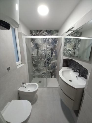 a bathroom with a toilet and a sink and a shower at A Casa Di Ugo in Fisciano