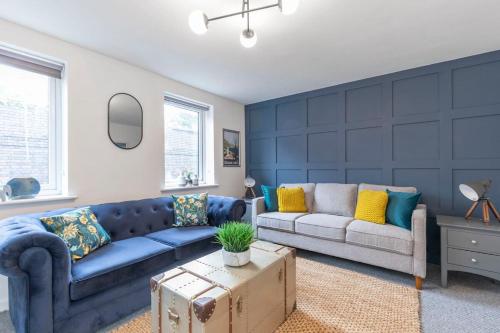 a living room with a couch and a table at Modern 4 Bedroom 4 Bathroom Home in Cheltenham in Cheltenham