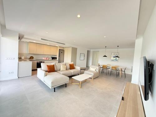 a living room with a couch and a table at Oceans Oliva in Oliva