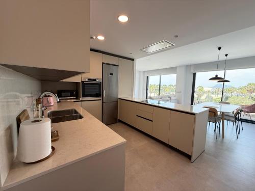 a kitchen with a counter and a dining room at Oceans Oliva in Oliva