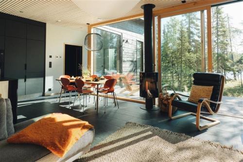 a living room with a dining table and chairs at Ruka Hideaway by Hilla Villas in Kuusamo