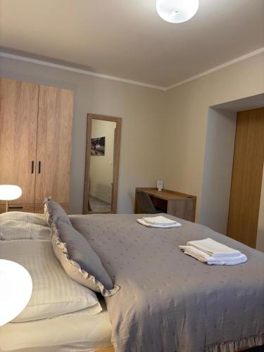 a bedroom with a bed with two towels on it at Penzion Apartmány Resident in Poděbrady