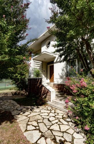 a white house with a stone walkway in front of it at Chambre 4 Rouge - WIFI - Proche gare in Labouheyre