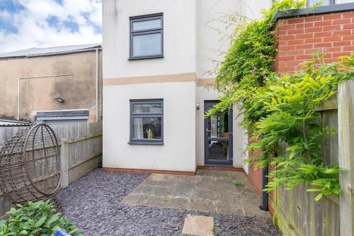 a house with a gate and a fence at Peaceful & Spacious 2 Bed Home in Cheltenham in Gloucestershire