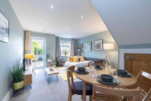 a living room with a table and a couch at Peaceful & Spacious 2 Bed Home in Cheltenham in Gloucestershire