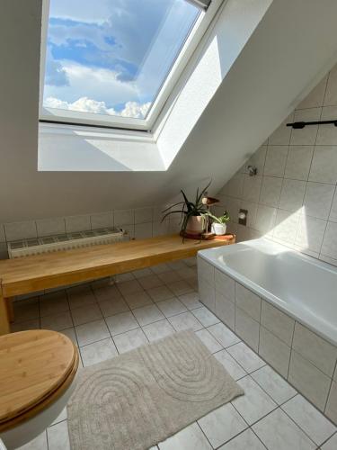 a bathroom with a large window and a bath tub at Lichtblick in Radebeul