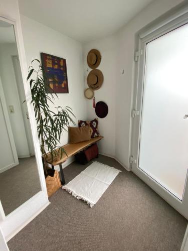 a room with a door and a plant and a mirror at Lichtblick in Radebeul