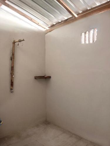 a room with a white wall and a window at Davi homestay in Sumbawa Besar
