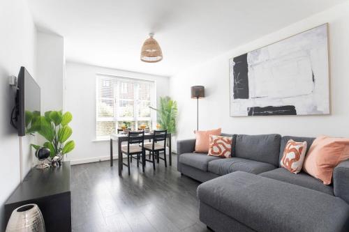 a living room with a couch and a table at Peaceful Two Bedroom Two Bathroom Home in Gloucestershire