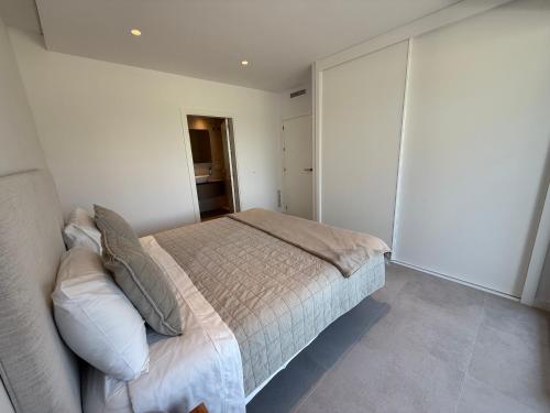 a bedroom with a bed and a closet at Oceans Oliva in Oliva