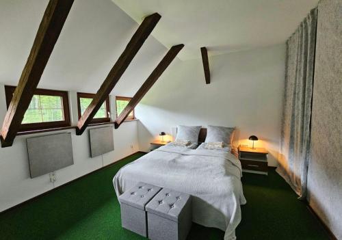 a bedroom with a white bed and two windows at Villa Alpine Spirit in Gösing an der Mariazeller Bahn