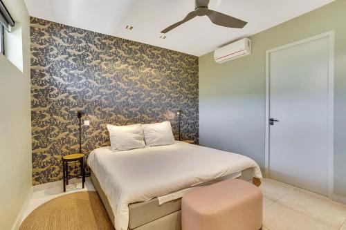 a bedroom with a bed and a ceiling fan at SENSES Boutique Hotel & Apartments in Kralendijk