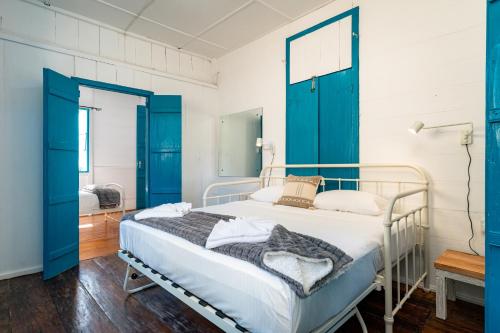 a hospital bed with blue doors in a room at Beach House Beau Vallon in Beau Vallon