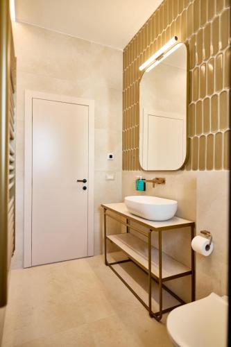 a bathroom with a sink and a mirror at Taria Resort in Poreč