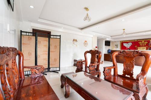 a dining room with wooden chairs and a table at Collection O Nam Phuong Hoang Hau Near Lotte Mart in Ho Chi Minh City