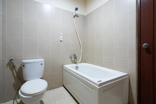 a bathroom with a toilet and a shower in it at Collection O Nam Phuong Hoang Hau Near Lotte Mart in Ho Chi Minh City