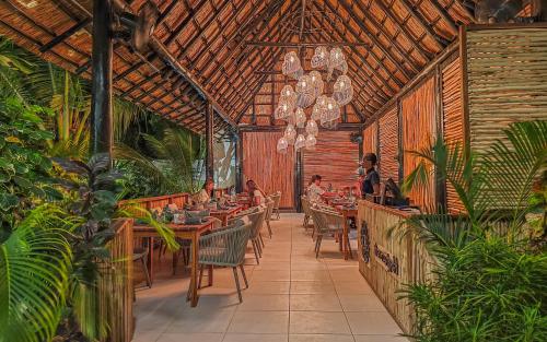 a restaurant with people sitting at tables in a patio at Z Hotel & Z2 Hotel in Nungwi