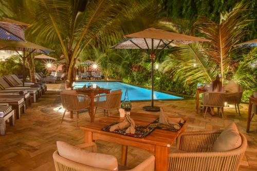 a resort with a pool and tables and chairs at Z Hotel & Z2 Hotel in Nungwi