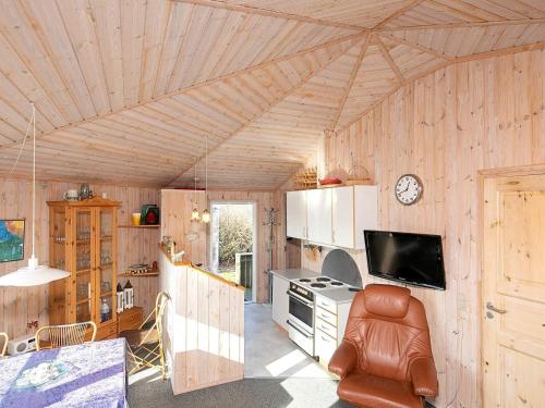 a kitchen with wooden walls and a ceiling at 4 person holiday home in Vinderup-By Traum in Vinderup