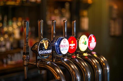 a row of keys lined up in a bar at The Bushel by Greene King Inns in Bury Saint Edmunds